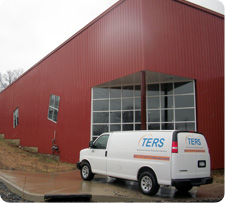 TERS company van near commercial building after weather storm - Total Environmental Restoration Solutions