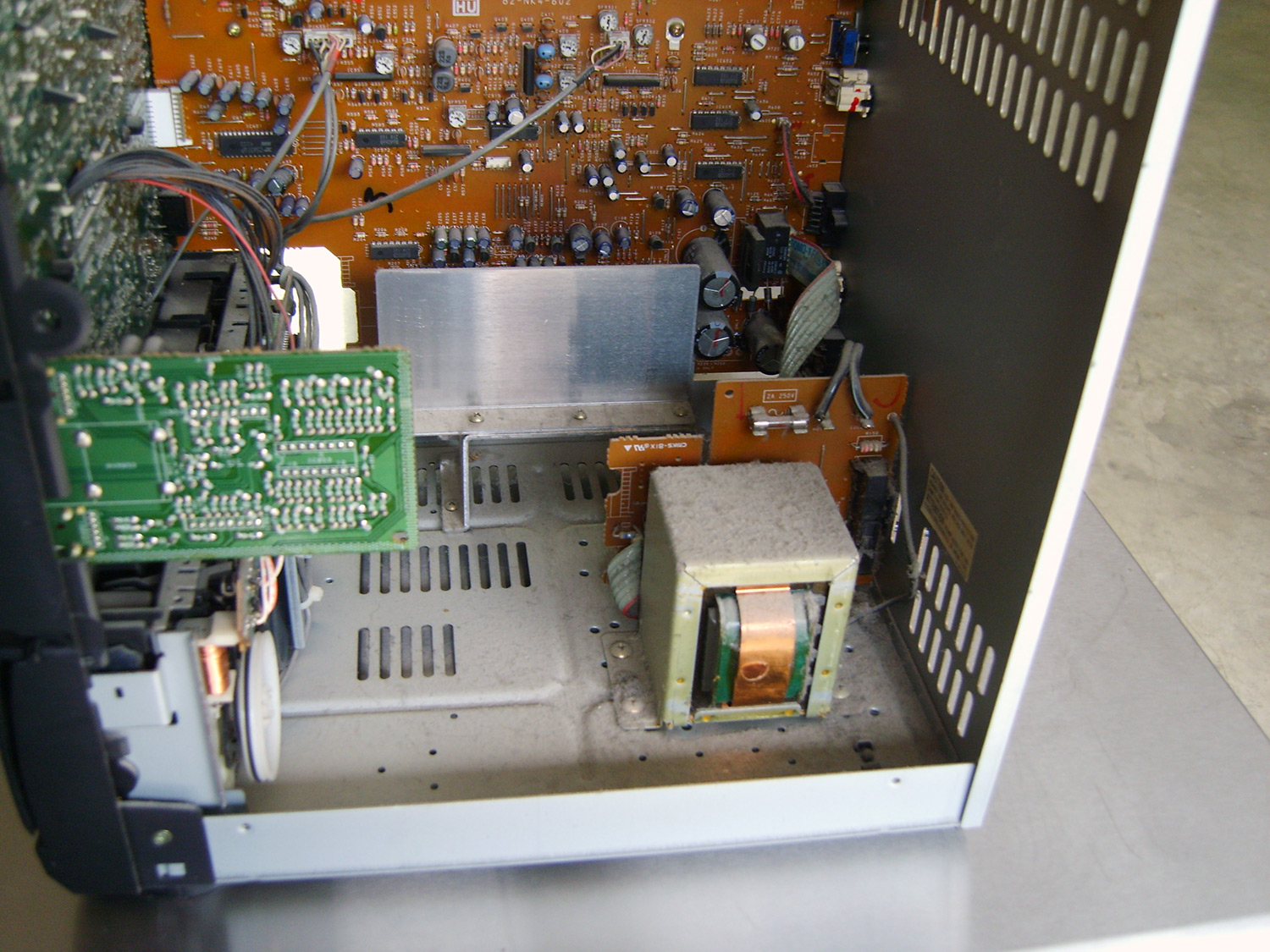 Open computer tower with chemical and dusty contamination on electronic components