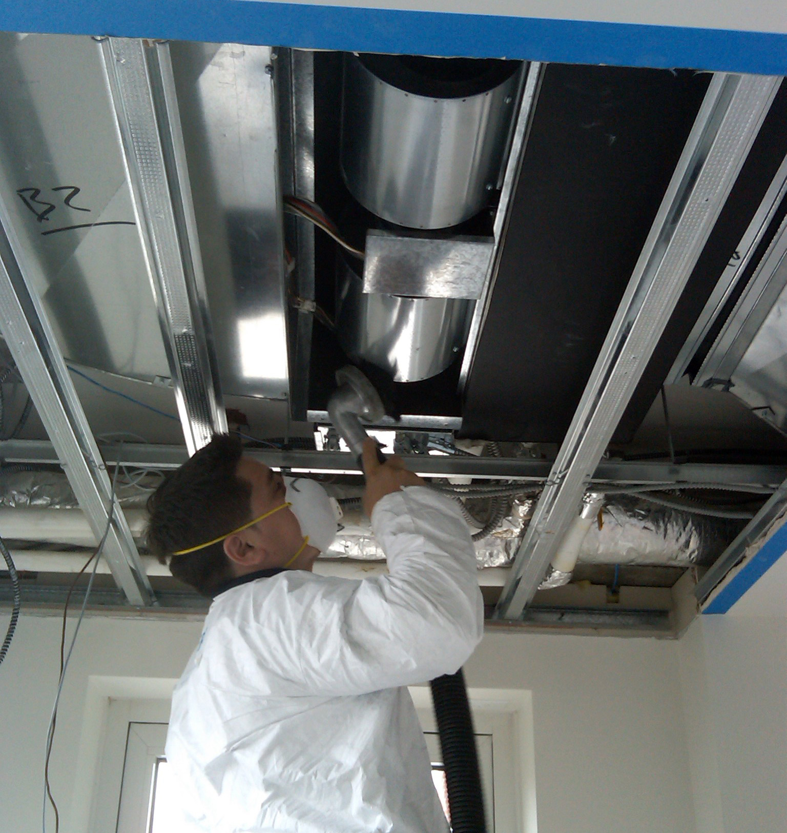 TERS duct cleaning specialist is removing dust and dirt from inside the commercial ductwork